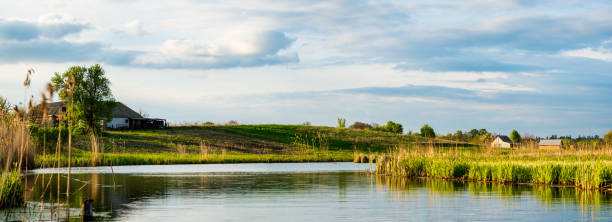 istock Village near the calm river 666647980