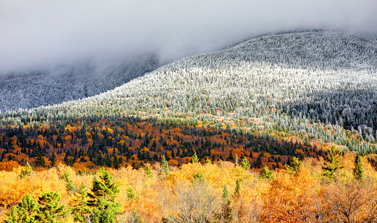 Autumn foliage and higher elevation snow on the slopes of Mt Washington in New Hampshire