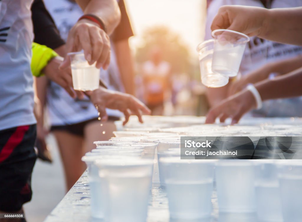 People running in city marathon on a street with sunrise Marathon Stock Photo