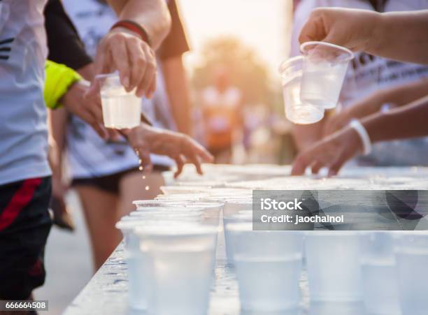 People Running In City Marathon On A Street With Sunrise Stock Photo - Download Image Now