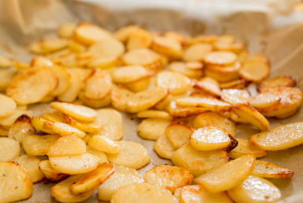 istock Baked potatoes slices on a roasting pan 666671038