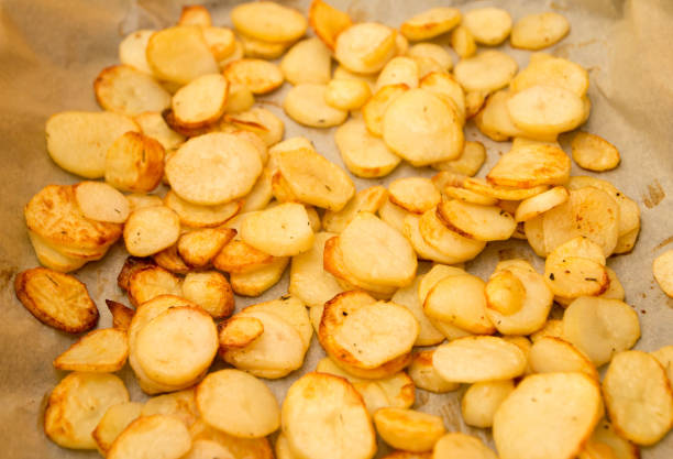 istock Baked potatoes slices on a roasting pan 666671042