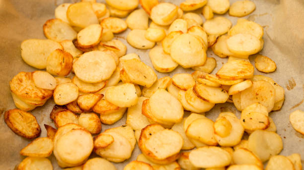 istock Baked potatoes slices on a roasting pan 666671044