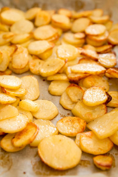 istock Baked potatoes slices on a roasting pan 666671056
