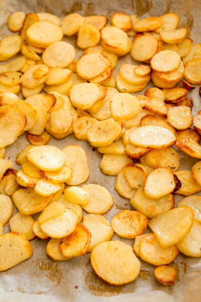 istock Baked potatoes slices on a roasting pan 666671068