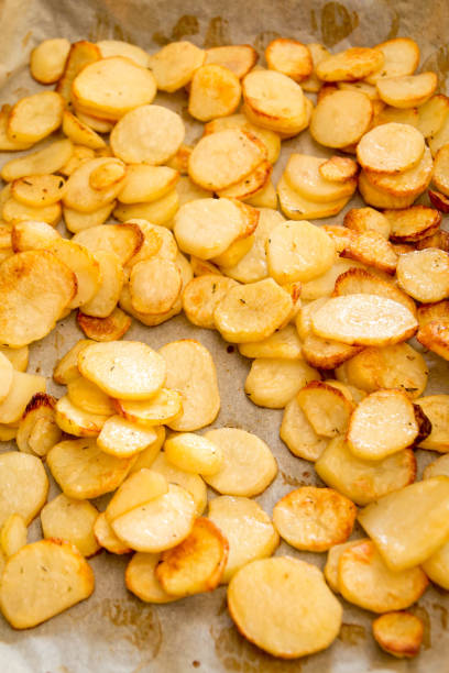 istock Baked potatoes slices on a roasting pan 666671082