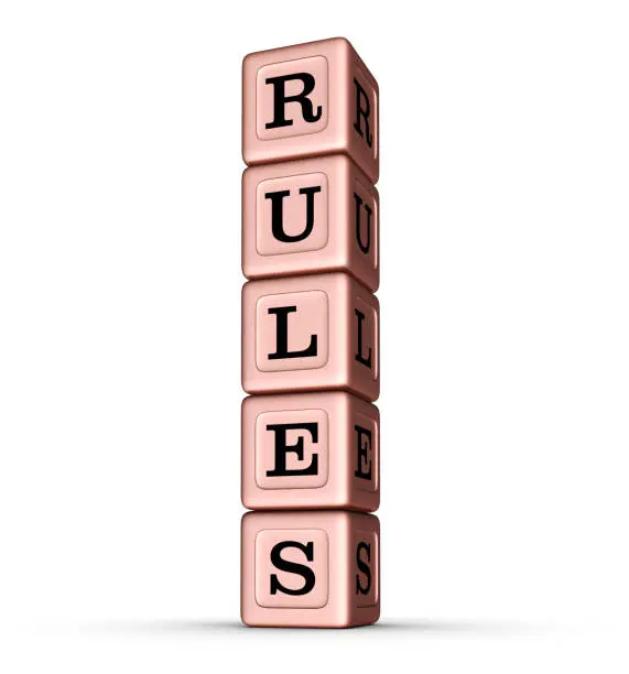 Photo of RULES word sign. Vertical Stack of Rose Gold Toy Blocks.