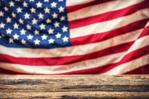 istock USA Flag. Empty old table and Usa flag in the background 666672318