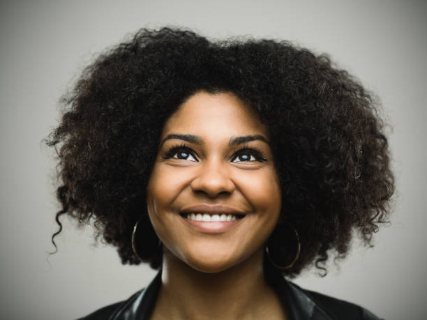 istock Beautiful young woman looking up and smiling 666672862