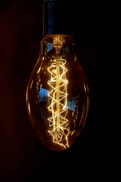 istock Edison light bulb hanging on a long wire. Cozy warm yellow light.Retro 666675404