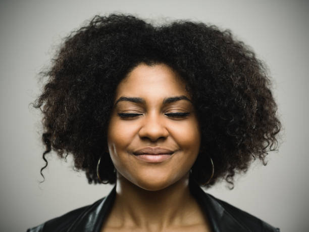 istock Young woman smiling with eyes closed 666675416