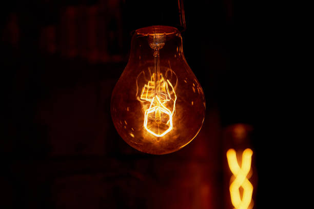 istock Edison light bulb hanging on a long wire. Cozy warm yellow light.Retro 666675574