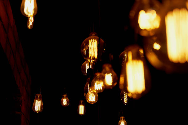 istock Edison light bulb hanging on a long wire. Cozy warm yellow light.Retro 666675608