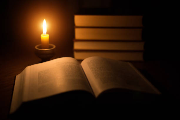 istock Concept of knowledge, vintage book candle 666678670
