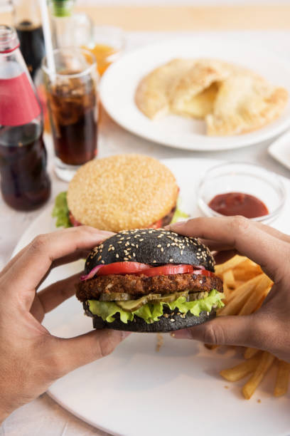 istock Man eating burgers 666686624