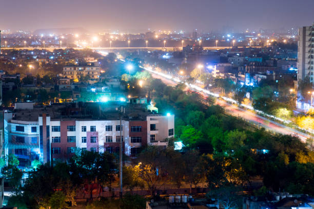 istock Noida cityscape at night with light trails on road 666702320