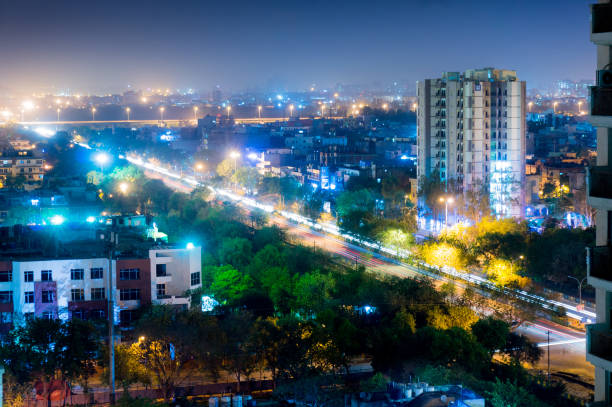 istock Noida cityscape at night with light trails on road 666705676