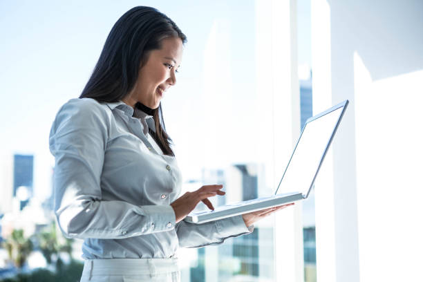 istock Smiling businesswoman using laptop 666708870