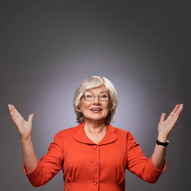 istock Happy senior lady with hands up 666709778