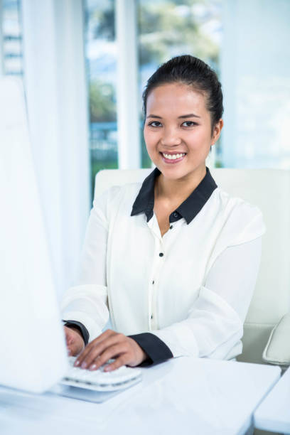istock Smiling businesswoman typing on her computer 666713142
