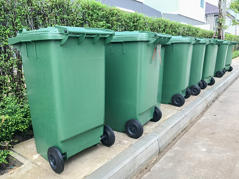 row of green plastic bin