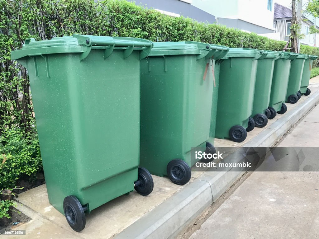 row of green plastic bin Green Color Stock Photo