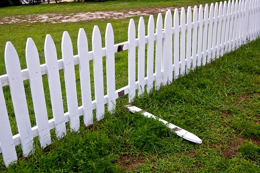 Broken white picket fence