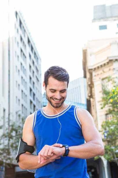 istock Smiling handsome athlete setting heart rate watch 666717502