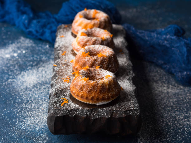 istock Bundt cakes on dark background and serving board 666717606