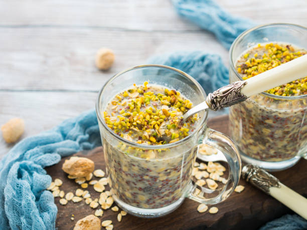 chia oat pudding with quinoa, banana, pistachio - quinoa spoon wood photography imagens e fotografias de stock