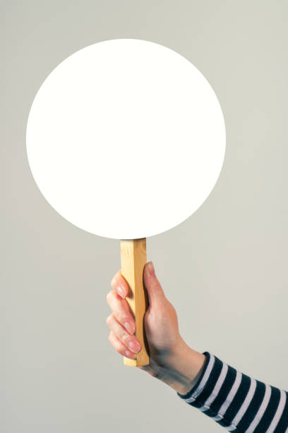 istock Female hand holding blank mock up banner sign as copyspace 666724342