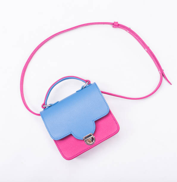 istock Pink and blue womans handbag isolated on white 666731950