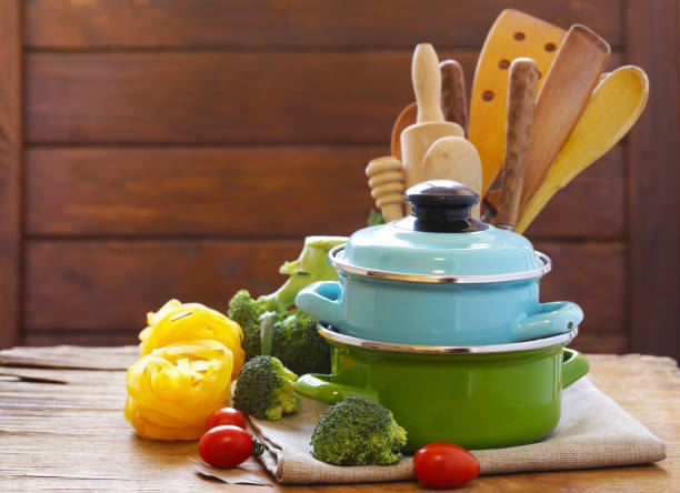 istock Kitchen tools - pots and cutlery on a wooden table 666747222
