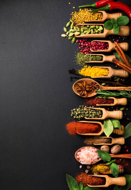 istock Background with various spices on black slate. Top view 666747548