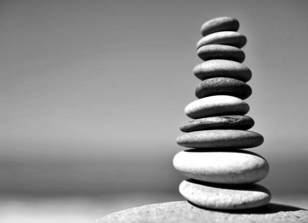 istock Stones pyramid on the beach with blue sky on background 666751090