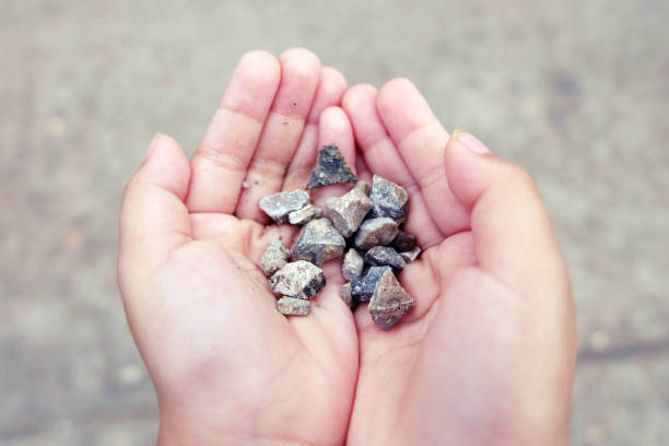 istock little girl hands holding small stones 666753842