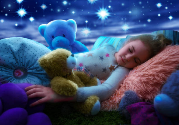 little girl sleeping with teddy bear in bed, dreaming the starry sky at bedtime night - sleeping child bedtime little girls imagens e fotografias de stock