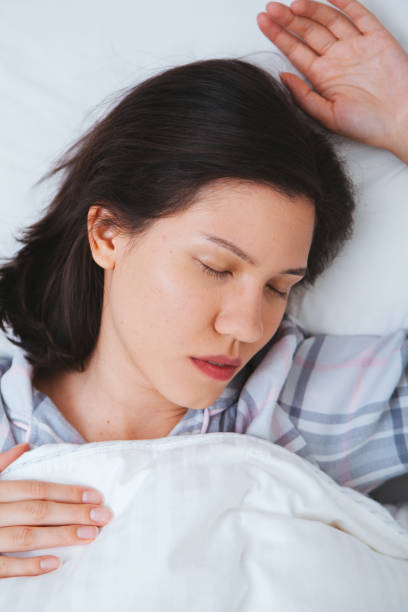 istock Woman sleeping in bed 666760396