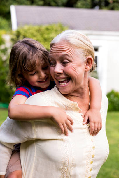 istock Grandmother carrying grandson at yard 666763448