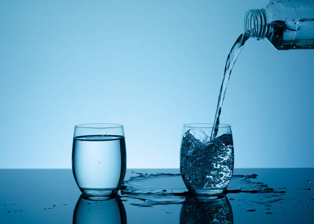 istock Bottle with creative splashing water in the glass 666763742