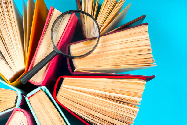 istock Top view of bright colorful hardback books in a circle. 666763884