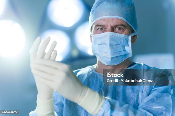 Serious Male Doctor Dressed In Special Uniform Stock Photo - Download Image Now - Surgeon, Portrait, Doctor