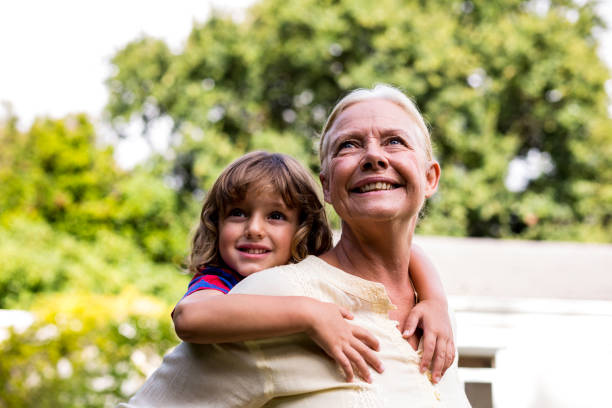 istock Grandmother carrying grandson at yard 666766710