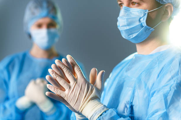 istock Concentrated doctors dressed in surgical uniform 666767040
