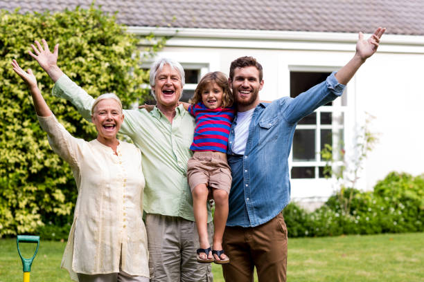 istock Father and son with grandparents stanidng  at yard 666769808