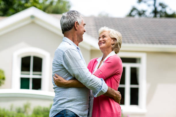 istock Smiling senior couple against house at yard 666772522