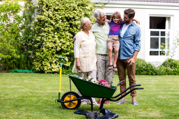 istock Father and grandfather carrying son at yard 666773278