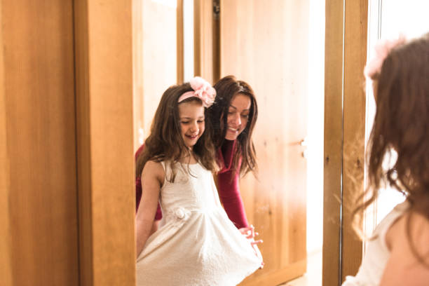 istock mother and daughter dressing up at the mirror 666773368