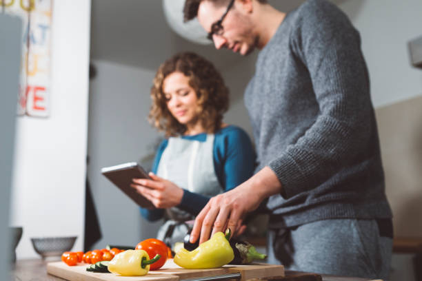 istock Couple cooking dinner at home 666782634