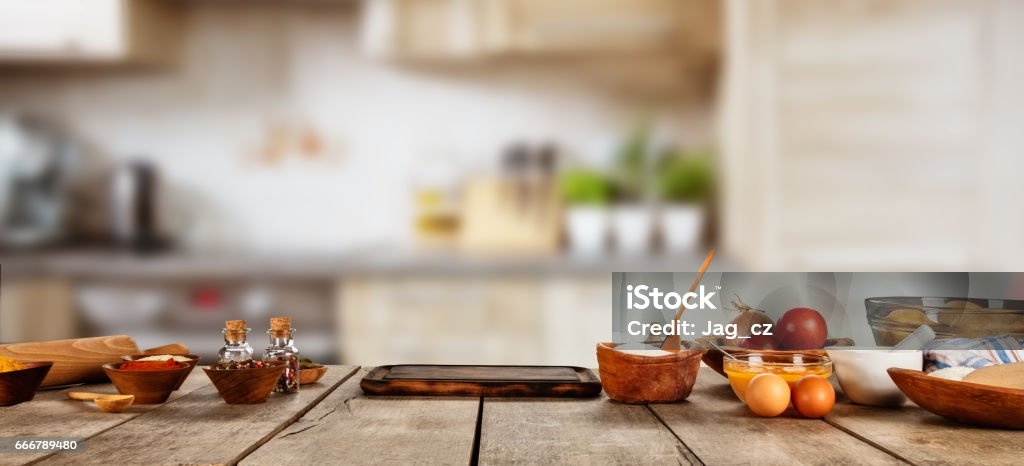 Baking ingredients placed on wooden table Baking ingredients placed on wooden table, ready for cooking. Copyspace for text. Concept of food preparation, kitchen on background. Table Stock Photo
